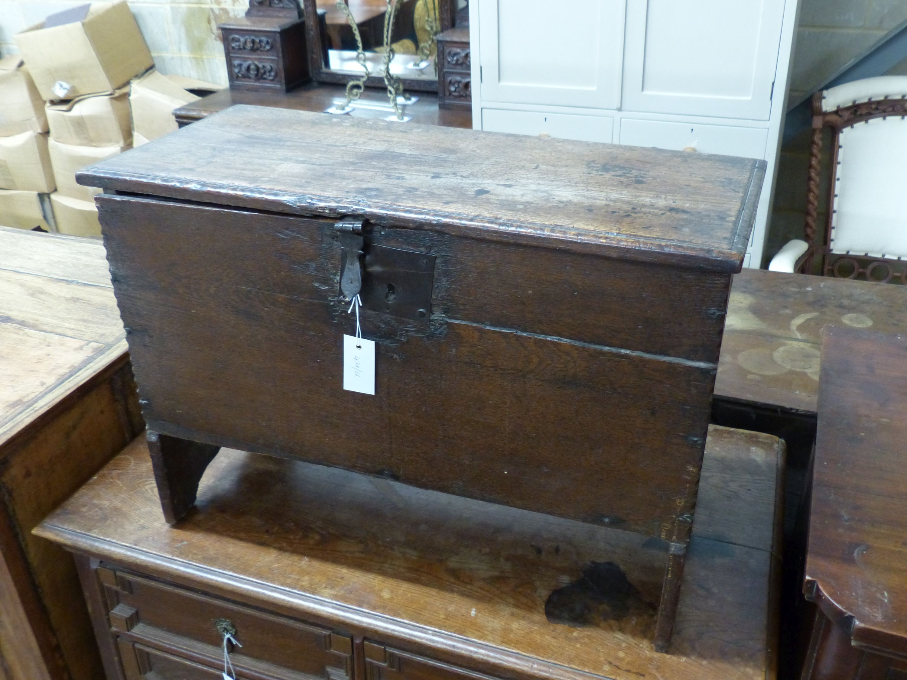 A 17th century oak six plank coffer with candle box (top a.f.), width 73cm